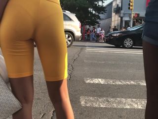 Black girl's thong is visible in orange shorts-7