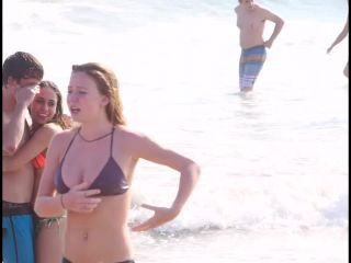 Busty ginger girl enjoys big waves in the water-1