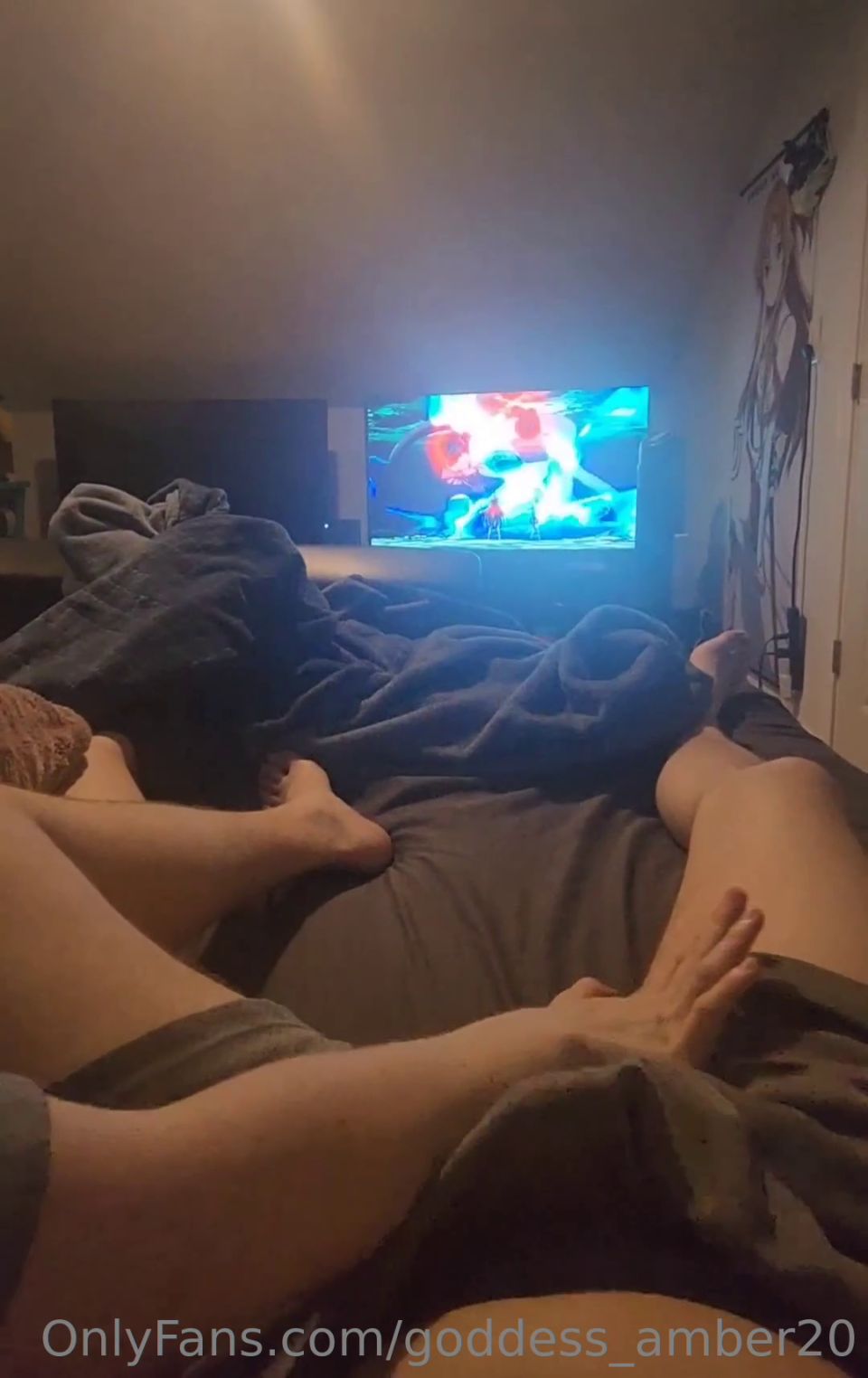 The girl kicks the guy in the balls while watching the movie.