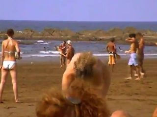 Woman undresses at a nudist beach-8