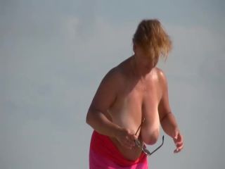 Gigantic mature tits on a beach-2