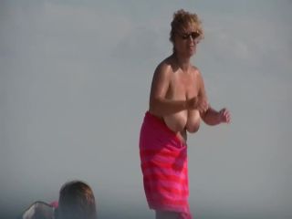 Gigantic mature tits on a beach-3