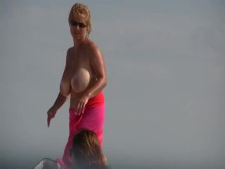 Gigantic mature tits on a beach-5