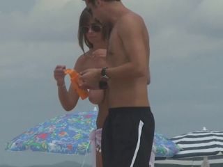 Topless milf gives back rub on beach-7