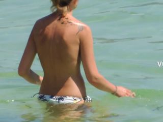 Perky tits of topless woman entering the water-3